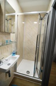 a bathroom with a shower and a sink at London Suite in London