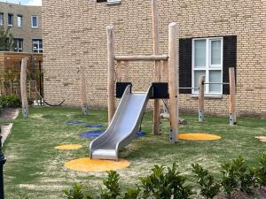 a playground with a slide in front of a building at BB aan de Zuyderzee in Bunschoten