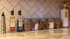 a counter with jars of food and bottles of wine at Sleep Inn in Jomala