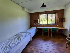 um quarto com uma cama, uma mesa e cadeiras em Thy Event & Naturcenter em Frøstrup