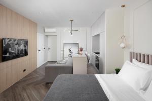 a bedroom with a bed and a living room at Savoia Apartment in Labin