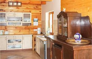 a kitchen with wooden cabinets and a counter top at Zakatek Mala in Kołczewo