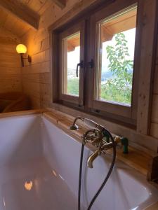 a bath tub in a bathroom with a window at Peaceful Oasis in Ulcinj