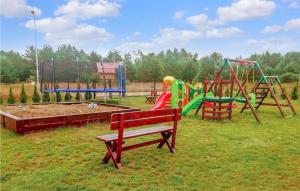 a park with a playground with benches and a slide at 2 Bedroom Nice Home In Bialogra in Białogóra