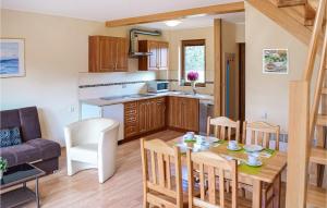 a kitchen and living room with a table and chairs at 2 Bedroom Nice Home In Bialogra in Białogóra