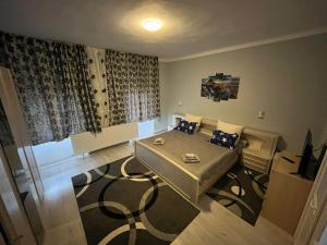 a room with a bed and a table in it at Pensiunea La Nety in Bozovici