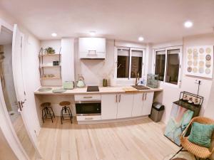a kitchen with white cabinets and a counter top at Cala Nova Studios, Vinaròs in Vinarós