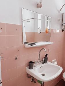 y baño con lavabo y espejo. en Wait 'n Sea Apartment by A&D Properties, en Porto Rafti