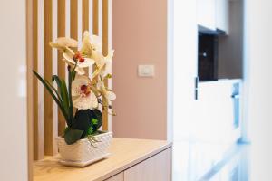 a vase of flowers sitting on a counter at Romantic getaway at West Residence in Oradea