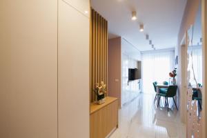 a room with a hallway with a table and a dining room at Romantic getaway at West Residence in Oradea