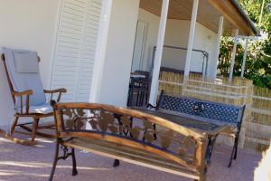 a bench sitting on the porch of a house at Ευχάριστη Βίλα, 90 μέτρα από τη θάλασσα in Agioi Theodoroi