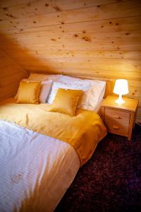a bedroom with a bed in a log cabin at The Crown Lodge in Zlatibor