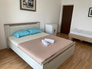 a bedroom with a bed with two towels on it at EM apartments in Ulcinj