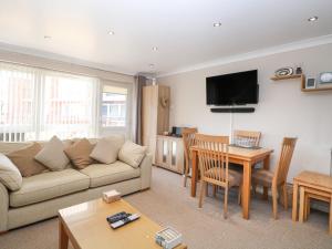 a living room with a couch and a table at 30 The Waterside Holiday Park in Lowestoft