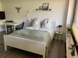 ein Schlafzimmer mit einem Bett, einem Tisch und einem Schreibtisch in der Unterkunft Fewo Lotte in Goslar + 9 Fotos