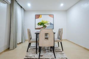 a dining room with a table and chairs at Sapphire Height Three Bedroom Apartment in Lagos