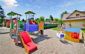 a playground with colorful play equipment in the sand at Stunning Home In Sianozety With Kitchenette in Sianozety