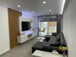 a living room with a couch and a tv at Casa Dru in Roquetas de Mar