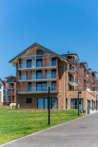 a large brick building on the side of a street at Apartmán Molo Lipno in Lipno nad Vltavou