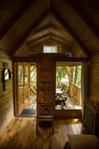 an inside view of a log cabin with a large window at Riverland in Gornji Zvečaj