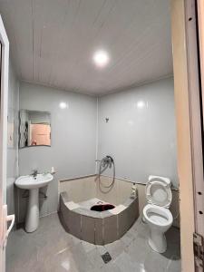 a bathroom with a tub and a toilet and a sink at Apartment Zaziashvili 30 in Tbilisi City