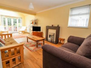 a living room with a couch and a fireplace at Crummock in Frodsham