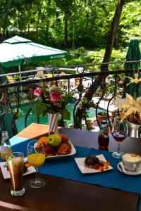 a table with a plate of food and drinks on it at Villa Bella Boutique Hotel in Kavadarci