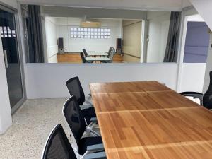a conference room with a wooden table and chairs at Moocoworking in Loei