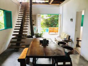 a living room with a wooden table and a spiral staircase at casa kashiikaii in Palomino