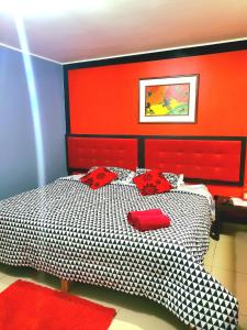 a bedroom with a black and white bed with red accents at Amaris Hotel in Ica