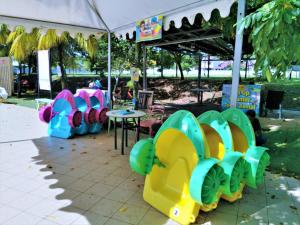 a group of chairs and tables in a park at HomeStay at Melaka # Free WiFi # Water ThemePark Tickets in Melaka