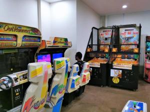 a man sitting in front of two video games at HomeStay at Melaka # Free WiFi # Water ThemePark Tickets in Malacca