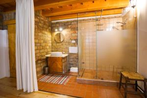 a bathroom with a glass shower with a sink at Borház Apartman in Eger