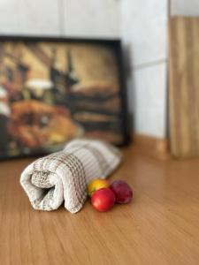 a towel on the floor with fruit on the floor at Sofis Garden in Kavala