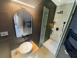 a bathroom with a toilet and a mirror at Engels apartment in Cluj-Napoca +7 photos