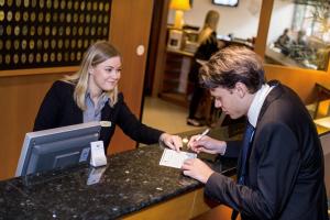 a man and a woman standing at a counter at 2Home Stockholm South in Stockholm