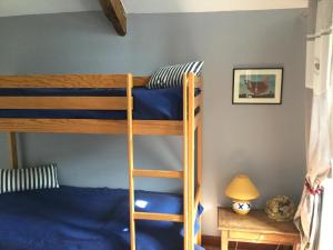 a bedroom with two bunk beds with blue sheets at Chambres d'Hôtes Domaine du Bois-Basset in Saint-Onen-la-Chapelle