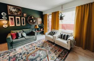 a living room with two couches and a window at Pieni lomahuoneisto ja ulkoporeallas in Mynämäki