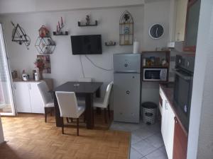 a kitchen with a table and a dining room at Apartmani Anja in Ohrid