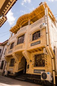 a building with a spiral staircase on the side of it at Durdona Guest House in Samarkand