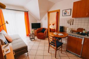 a kitchen and a living room with a table at Bio-Weingut Staffelter Hof in Kröv