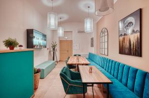 a restaurant with blue seats and tables in a room at Salvator Boutique Hotel vegan-friendly in Prague