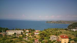 a town on a hill next to a body of water at bellavista appartment in Piran