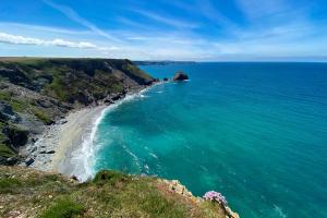 an aerial view of the ocean and a beach at Rosebud in Portreath