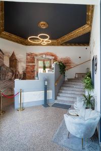 a lobby with a staircase and a stair case at Hotel Polonia in Toruń