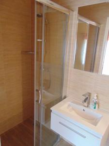 a bathroom with a shower and a sink at Gosciniec Pod Brzegiem in Ustroń