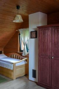 a bedroom with a bed and a wooden ceiling at Rose Hip Hill Farm in Valea Tîrnei