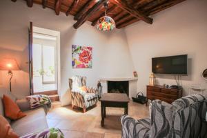 ein Wohnzimmer mit einem TV und einem Kamin in der Unterkunft Can Jaume Guillem in Sant Carles de Peralta