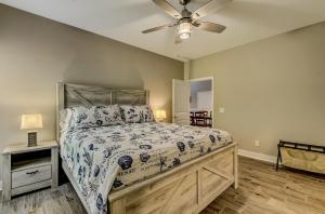 a bedroom with a bed and a ceiling fan at Fisherman's Paradise at Crooked River with Stay Better Vacations! in Elliotts Bluff