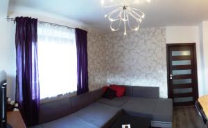 sala de estar con sofá y lámpara de araña en Apartman Chopok, en Liptovský Mikuláš